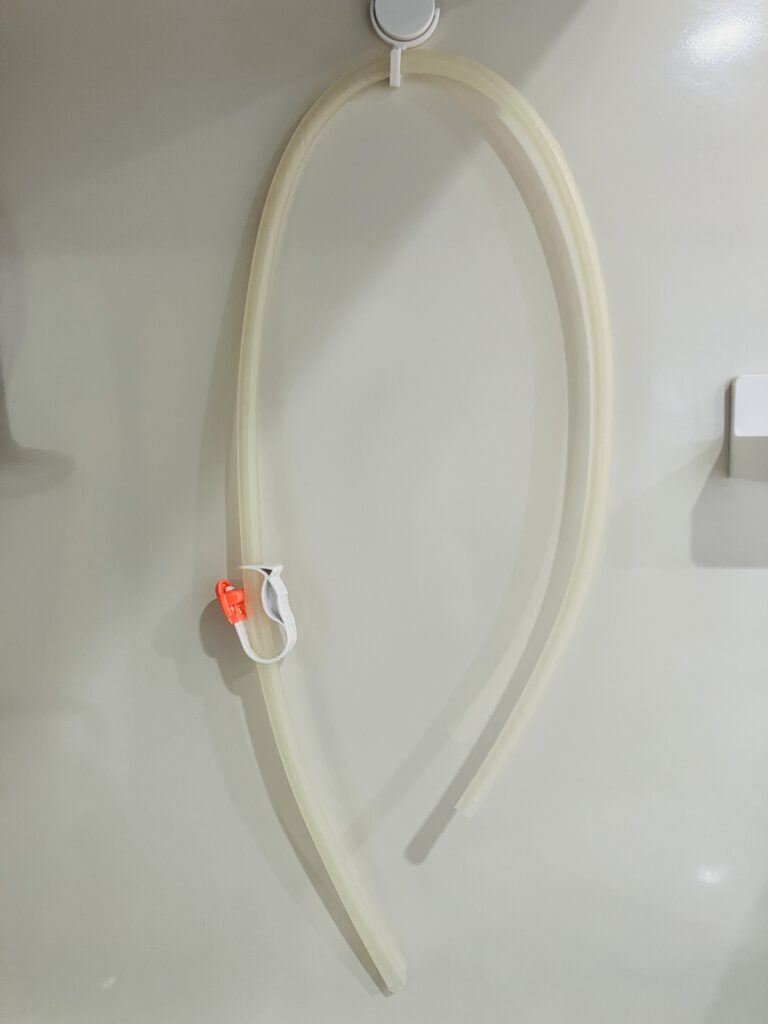 洗ったチューブをフックにかけて干している